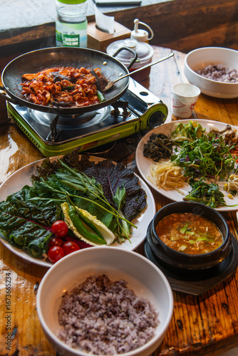 traditional Korean dinner table with various foods including ssambap