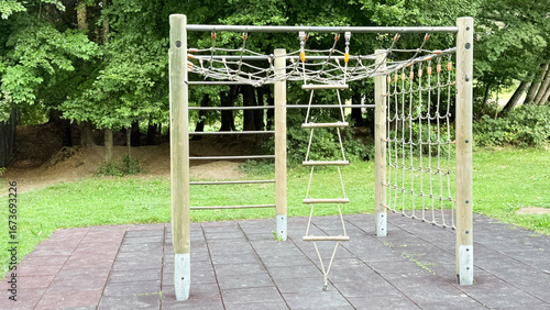 Eco wooden playground climbing structure for children with ropes and nets, outdoor play area for kids, natural park equipment for recreation and fun. High quality photo
