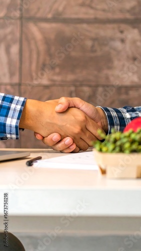 Business handshake on table