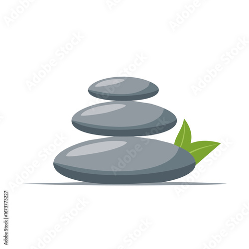 Smooth gray spa stones stacked in balance with fresh green leaves.