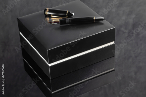 Fountain pen on dark marble background. Rare writing instruments.