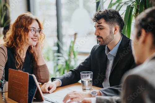 Professionals engage in a productive discussion at a rustic co working cafe setting, fostering collaboration and innovation. The relaxed ambiance adds to the congenial and focused tone of the meeting.