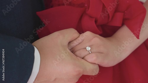 Couple holding hands, fingers intertwined