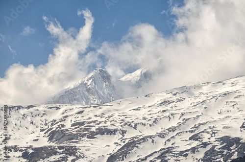 Snowy mountain peak and clouds