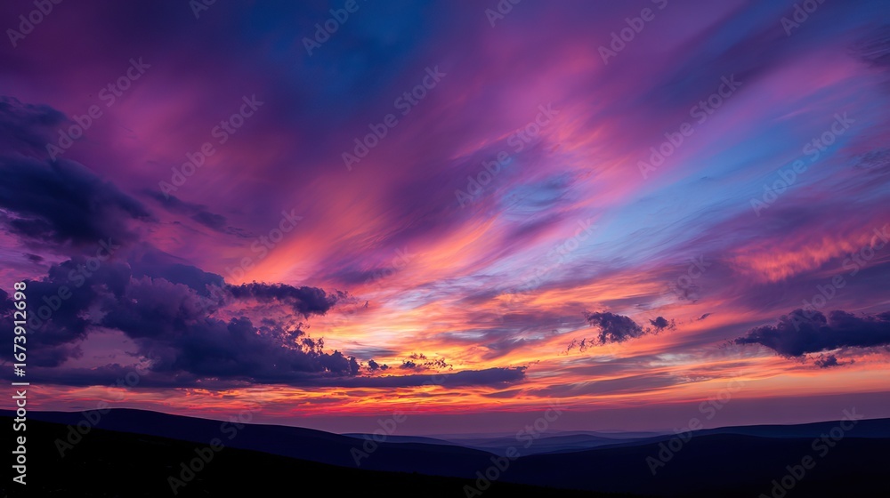 Fototapeta premium The vibrant sunset sky filled with shades of pink, purple, and orange, with clouds forming intricate patterns, further added to the overall beauty of the scene.