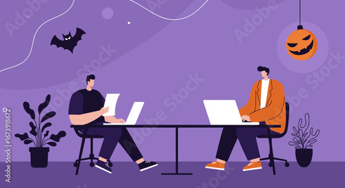 Two colleagues work on laptops at a shared desk in a modern office decorated for Halloween with a pumpkin lantern and bat. Represents seasonal business, remote work, and teamwork.