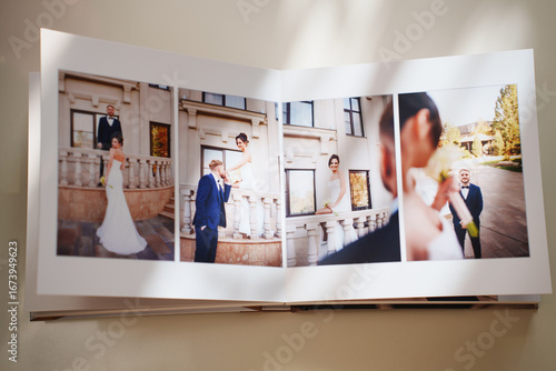  an open photo book with wedding photos on a white table