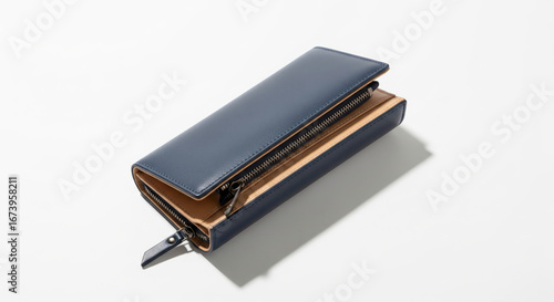 Elegant blue leather wallet with zipper closure displaying interior tan lining on a clean white surface showcasing quality craftsmanship and modern design