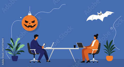 Professionals working on laptops at an office desk, decorated for Halloween with a pumpkin ornament and bat. Represents seasonal business, teamwork, and modern workplace.
