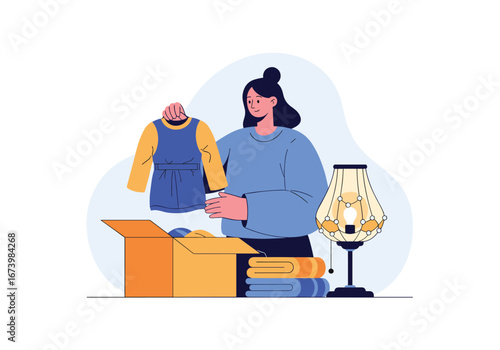 Woman is packing clothes into a box for donation or moving to a new home preparing for a fresh start