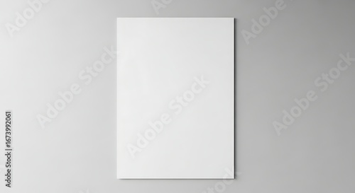 Vertical poster mockup with a minimalist design on a plain gray wall background.