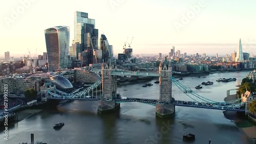 Aerial view of the london skyline at sunset, featuring the iconic tower bridge and modern skyscrapers along the river thames
