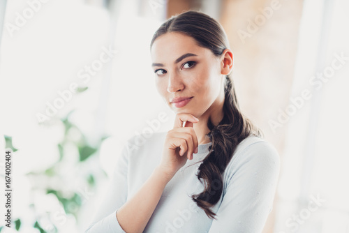 Confident young woman with thoughtful expression in modern interior under natural daylight Free Download Confident young woman with thoughtful expression in modern interior under natural daylight - GFXLoad