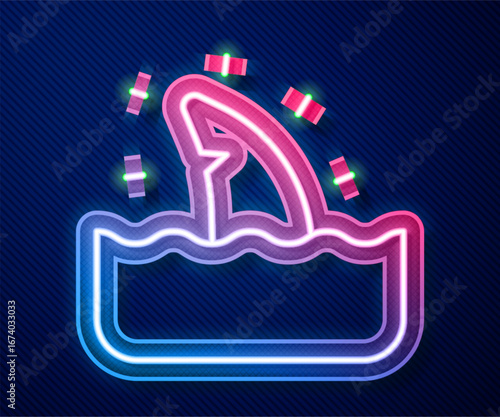 Glowing neon line Shark fin in ocean wave icon isolated on blue background. Vector