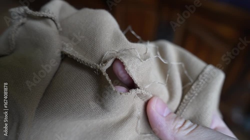 Close-Up of T-Shirt Falling Apart at Seams – Stitches Unraveling and Fabric Damage