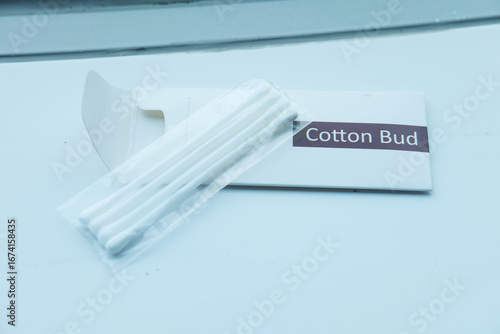 A set of hotel cotton buds, still sealed in their minimalist white packaging, photographed with a clean, bright aesthetic.