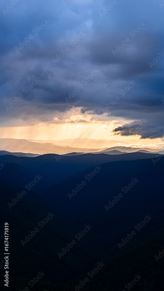 Fototapeta premium sunbeams before or after rain, thunderstorms, play of light in the mountains