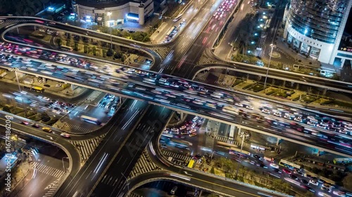 traffic jam on highway streets at evening. Drone top view of freeway road junctions. Cars drive through Traffic jam in an urban city streets at night.