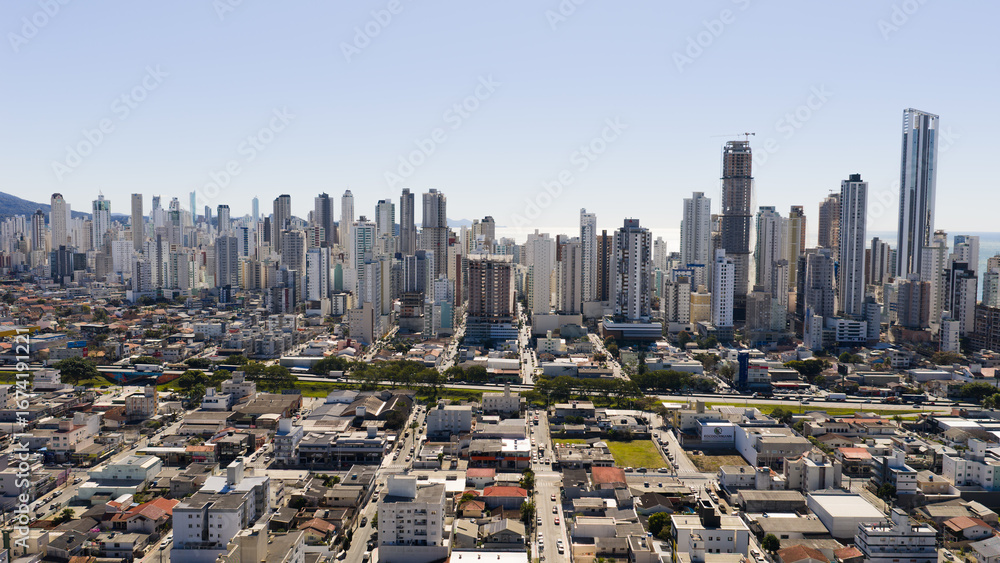 Fototapeta premium Aerial view from inland side of Balneário Camboriú showcasing dense skyline and modern architecture.