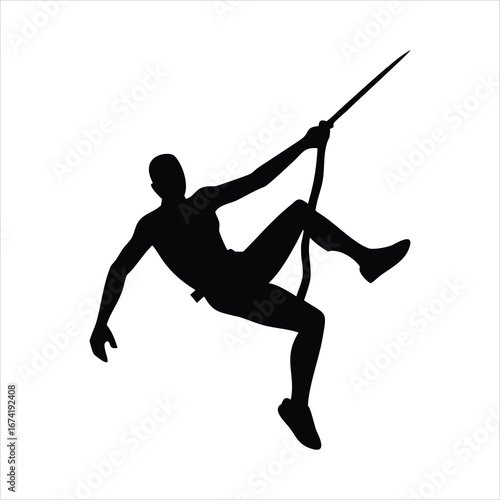 Silhouette of a rock climber rappelling down a cliff