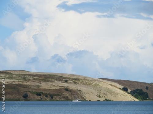 Fotografi beautiful Dead dunes in Curonian spit, Lithuania, Europe with a curonian lagoon
