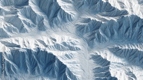 Wallpaper Mural High-angle view of snow-capped mountain ranges.  Sharp peaks and valleys.  Cool blue tones Torontodigital.ca