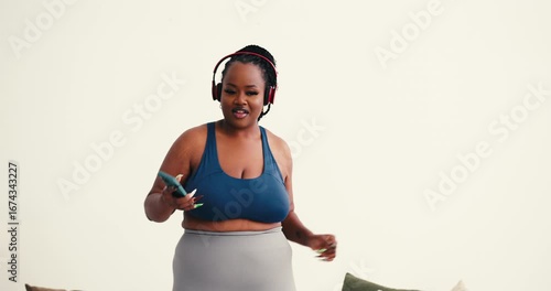 Confident African American woman dances in home workout gear