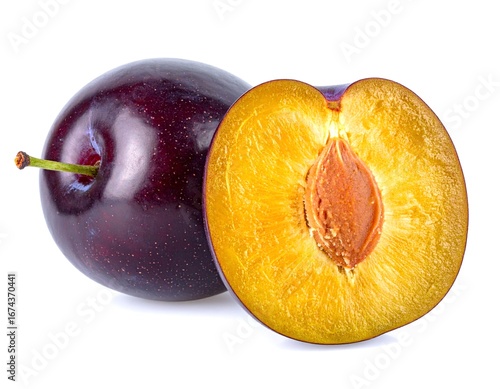 Ripe plums displaying juicy interior with seed on white background