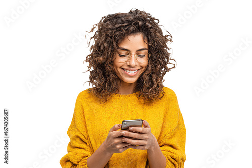 Young woman uses phone. Smiling woman wearing yellow sweater checks her phone. Lifestyle, social media, ads.
