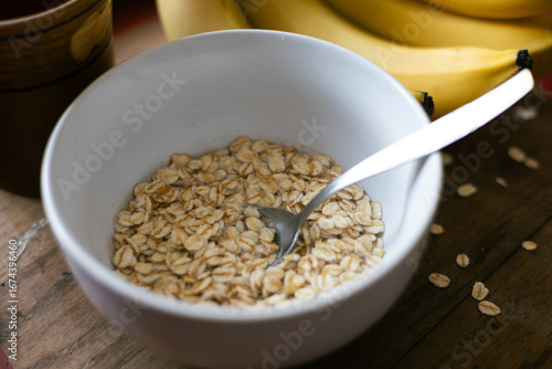Schilderij op canvas Healthy breakfast bowl with oats and bananas, perfect for a nutritious start to