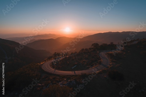 Sunset Over Scenic Mountain Highway from Above