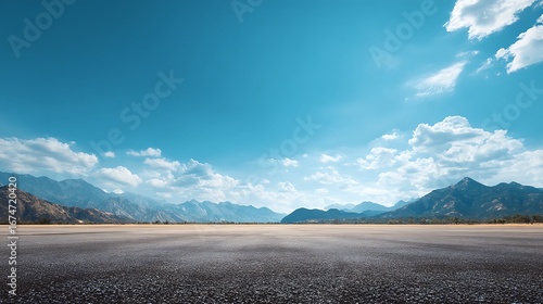 A wide-angle ground with a clear sky and mountainous background for vehicles or products placement. Copy space image. Place for adding text or design ... See More.