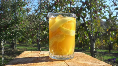 Iced apple beverage in orchard setting