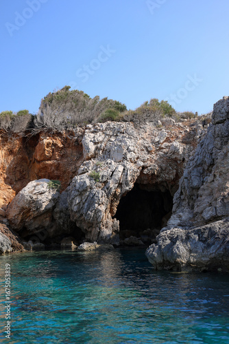 Natural cave in rock and mysterious atmosphere on mediterranean sea