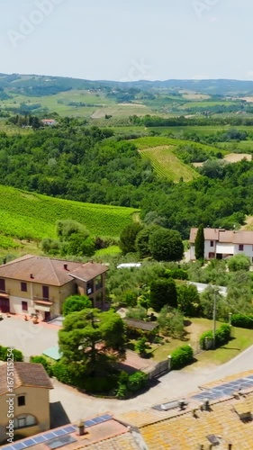 Wallpaper Mural Vertical drone shot following a RV driving between vinyards and a Tuscan town Torontodigital.ca