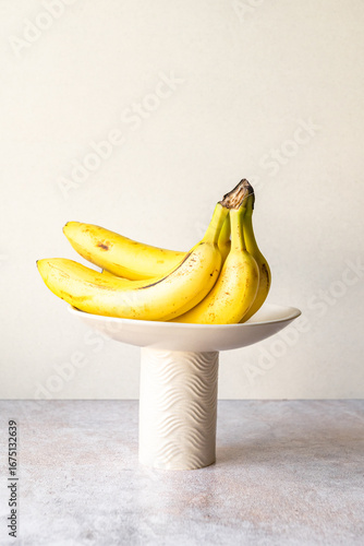 Handmade ceramic cake stands and pedestal bowls with fresh fruit display as table centerpieces 