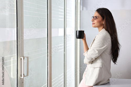 Woman Enjoying Coffee While Looking out the Window