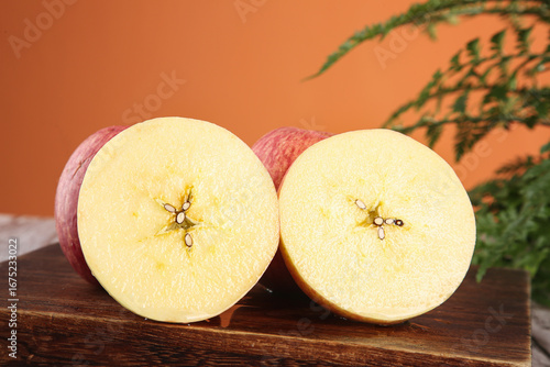 Fresh Red Striped Fuji Apples from Shandong Luochuan Cut in Half on Wooden Board