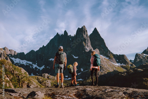 Obraz na plátně Family backpackers climbing mountains in Norway - dad, mom and child hiking in L