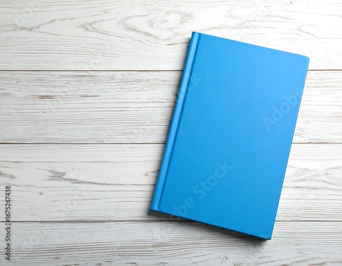 Blue book on a white wooden table