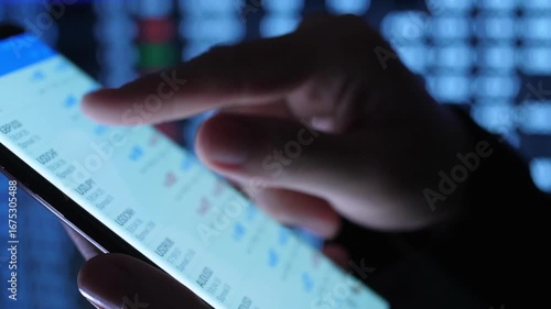 Close up side view trader holding cellphone in broker media trading stock market in blurred background Technology concept