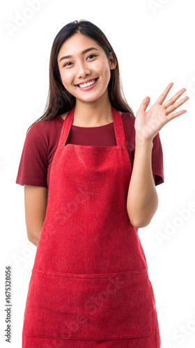 A woman in a red apron is smiling and waving