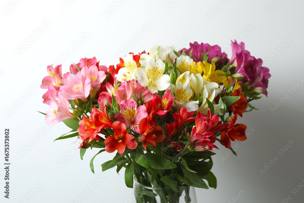Obraz premium Beautiful alstroemeria flowers in a vase on the table, space for text 