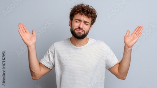 Man with arms raised in surrender or apology facial expression of regret isolated 