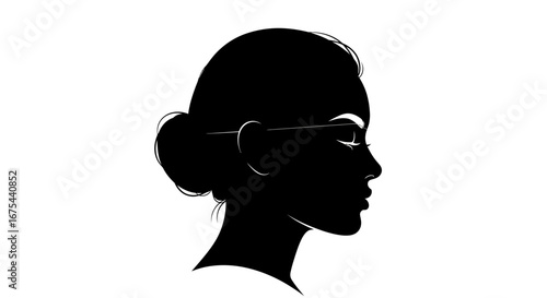 Silhouette of a woman wearing glasses with her hair in a bun against a white background