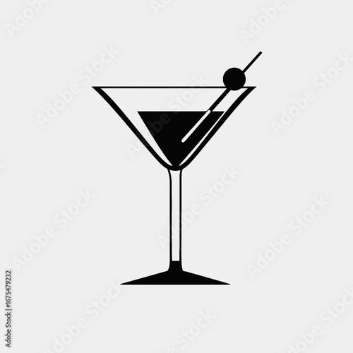 Elegant martini cocktail glass with olive garnish dark silhouette