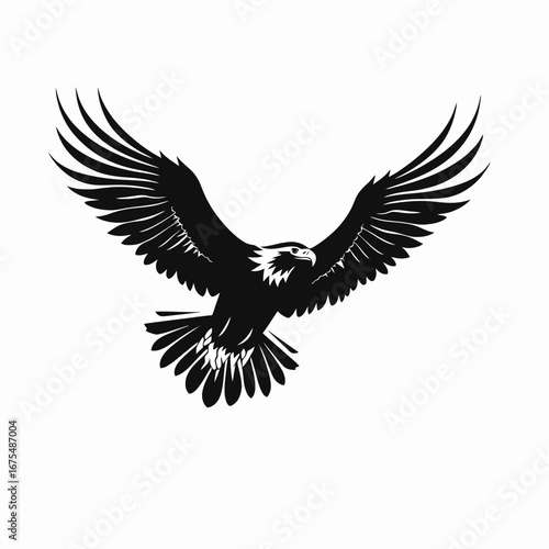 Majestic bald eagle soars with its wings spread wide creating dramatic silhouette