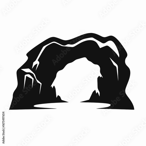 Mysterious dark cave entrance and rocky archway creates an atmospheric silhouette