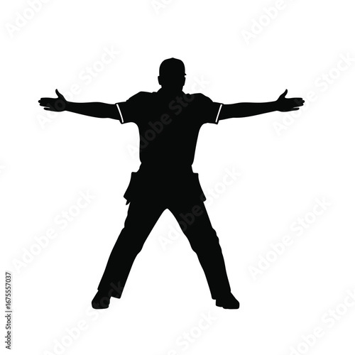 Person with arms outstretched wearing cap silhouette