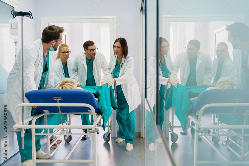 Obraz premium Senior Woman on Gurney with Diverse Medical Team in Hospital Hallway